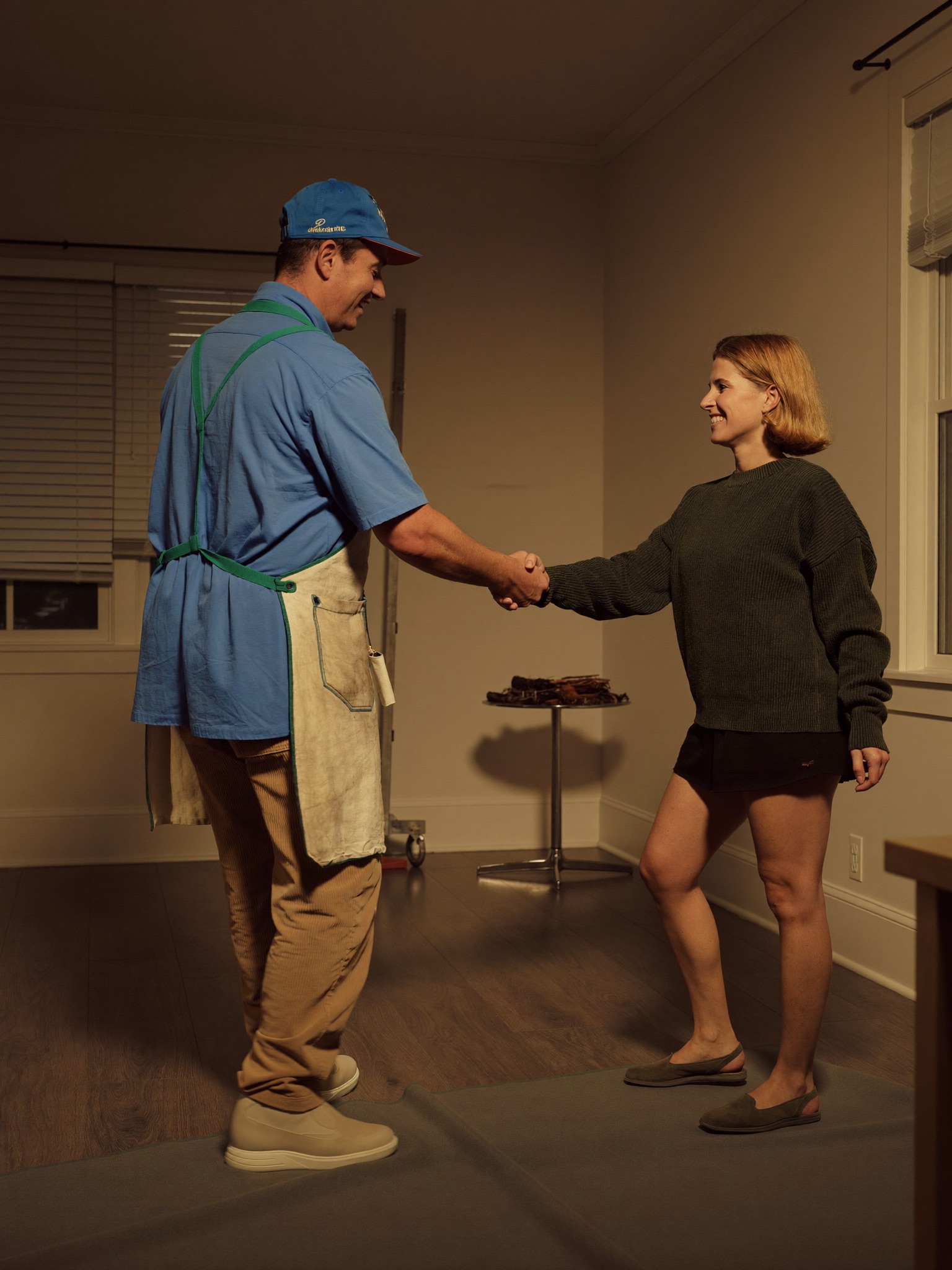 Painter shaking hands with a happy homeowner